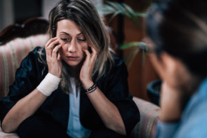 woman holding face in hands needed anxiety and depression treatment