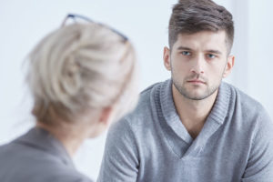 man listening to what is dual diagnosis treatment being explained
