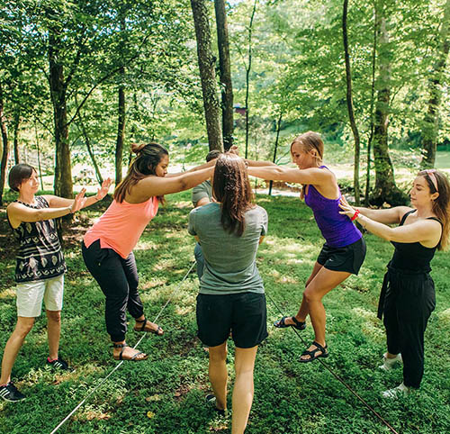 group of women on low ropes