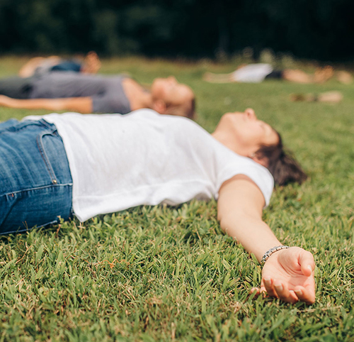 patients lying on grass outside