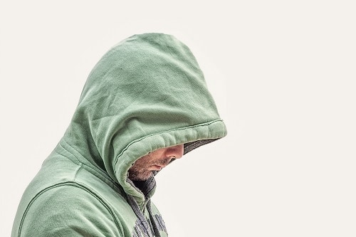 hooded figure needing trauma informed treatment for addiction