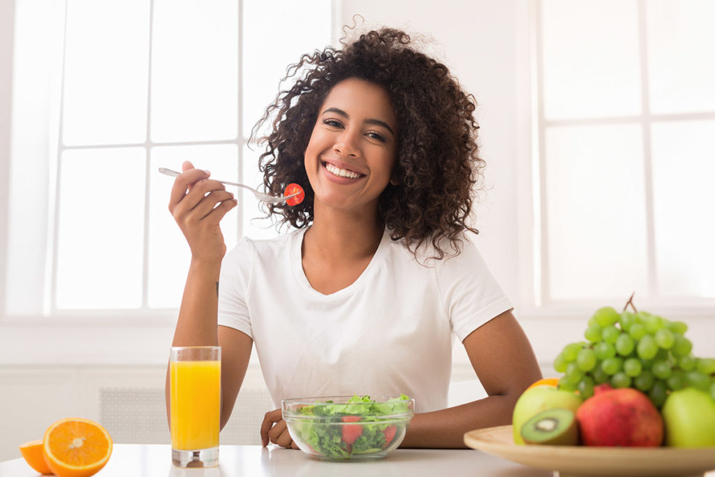 woman smiling while eating for your microbiome