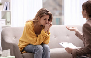 woman listening to therapist while in an intimacy disorder treatment program