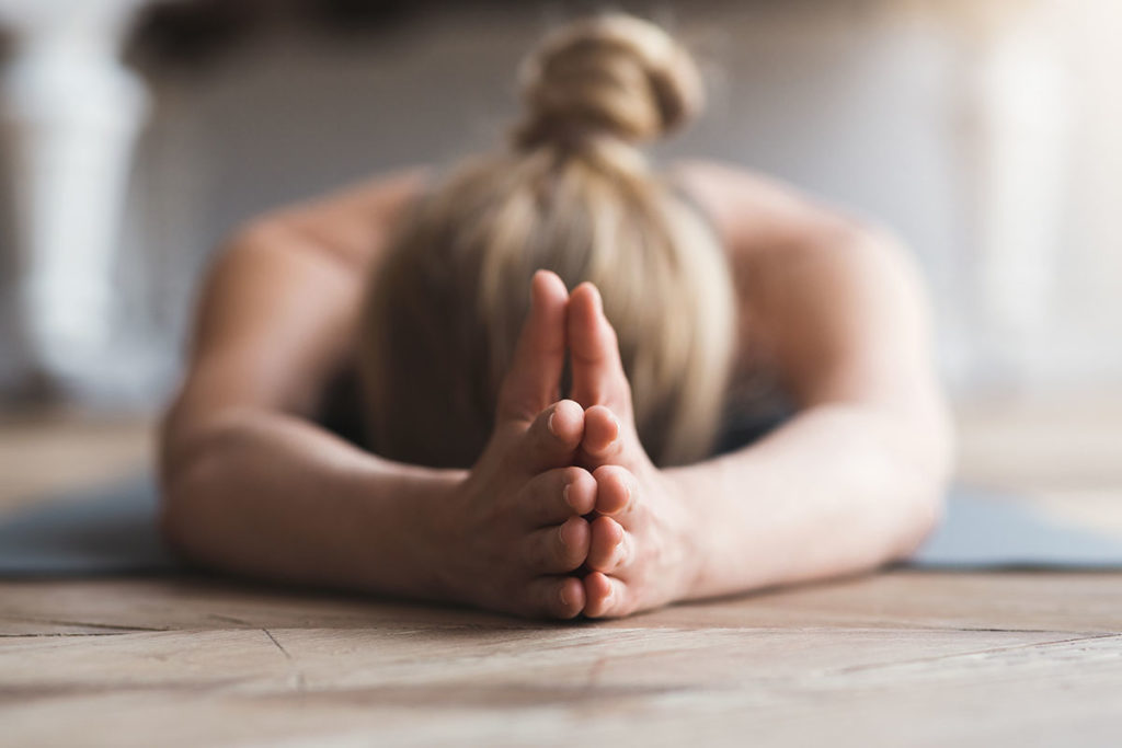 woman doing yoga experiencing meditation and recovery