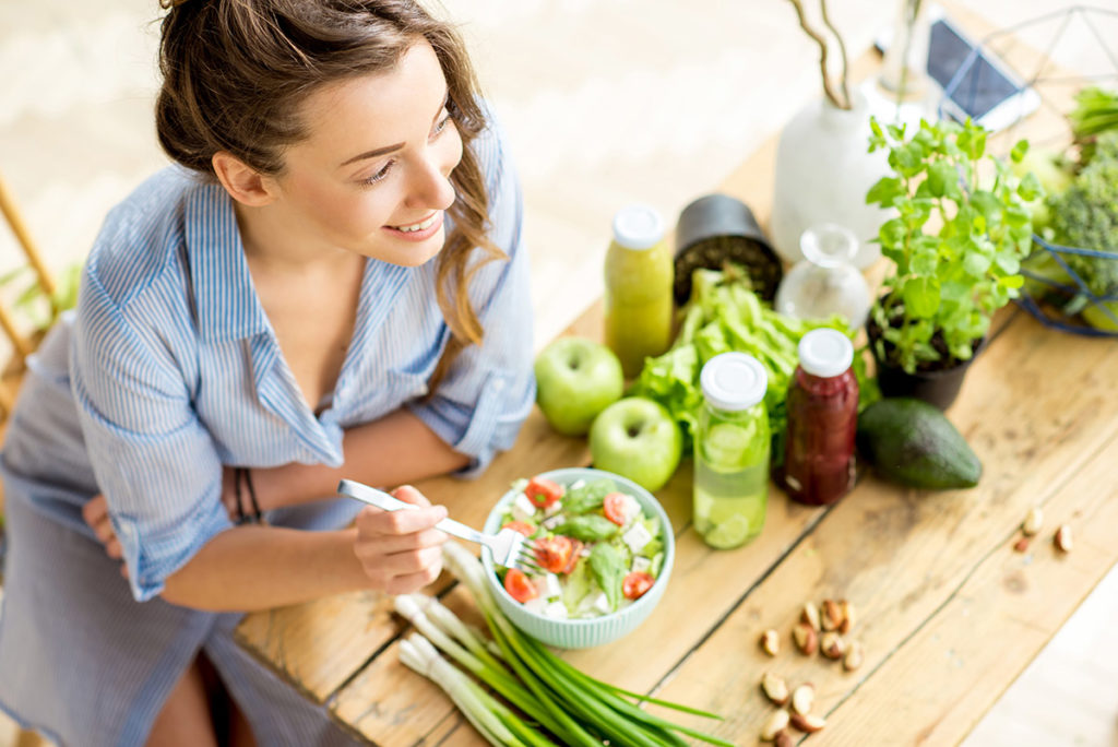 woman eating fresh food in healthy food relationships