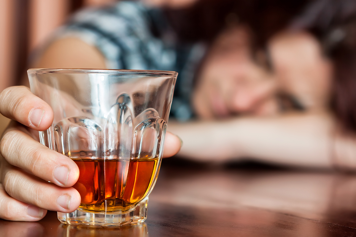 person passed out with glass of liquor dealing with alcohol and anxiety