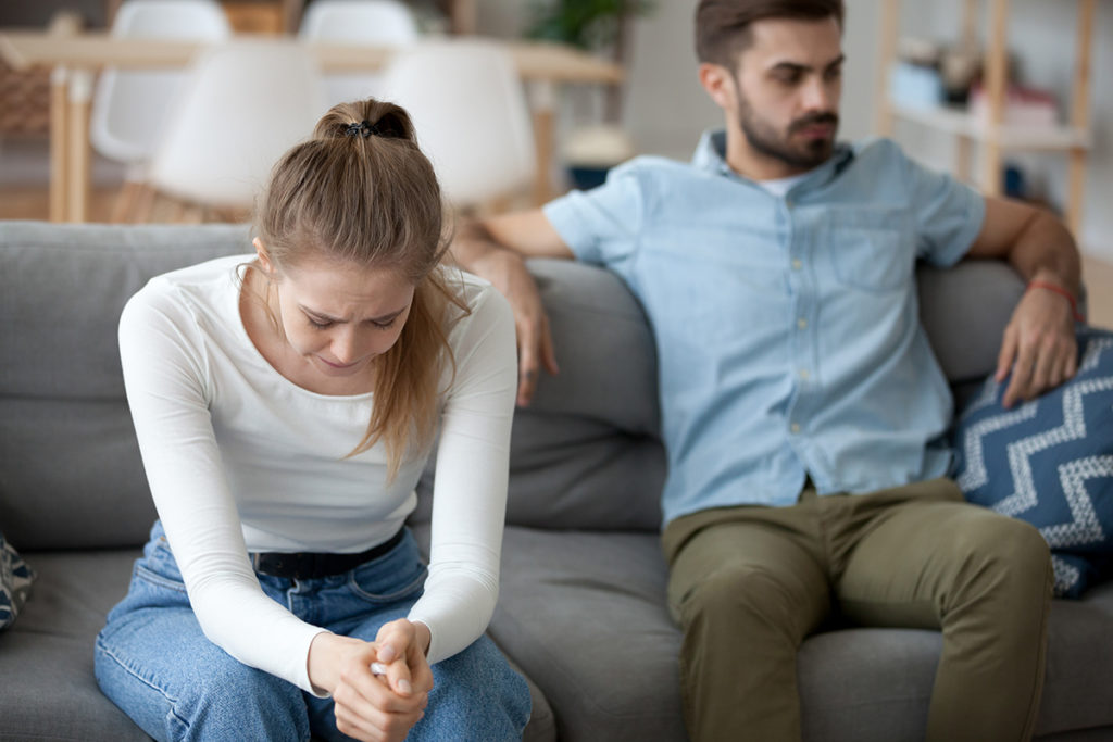 couple on couch dealing with loved one with addiction