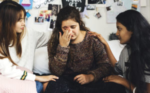sisters talking to help their loved one get grief counseling