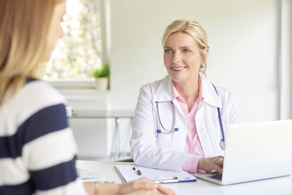 woman speaking with a doctor about residential treatment
