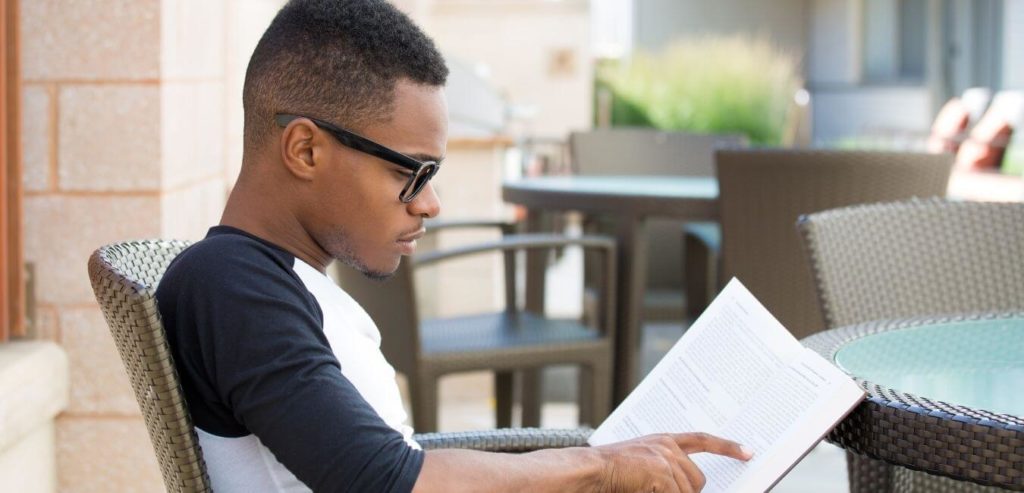 man focuses on his journal