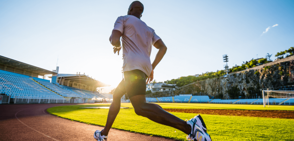 Man running on sports track early morning