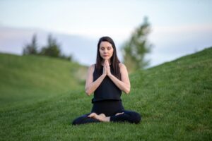 woman on green grass field during daytime, practicing meditation for alcohol recovery