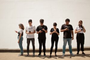 group of people standing on brown floor, is deleting social media a sign of depression