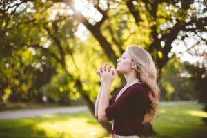 woman praying under tree during daytime, is relapse part of recovery