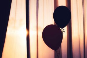 two balloons near brown curtain, is substance abuse genetic