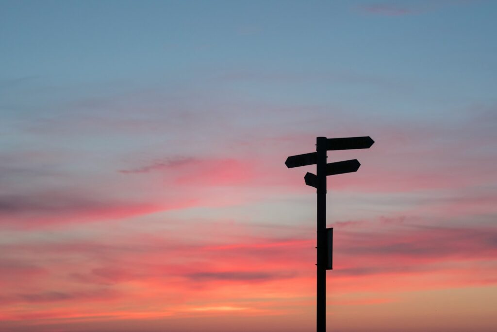 silhouette of road signage during golden hour, is addiction a disease or a choice