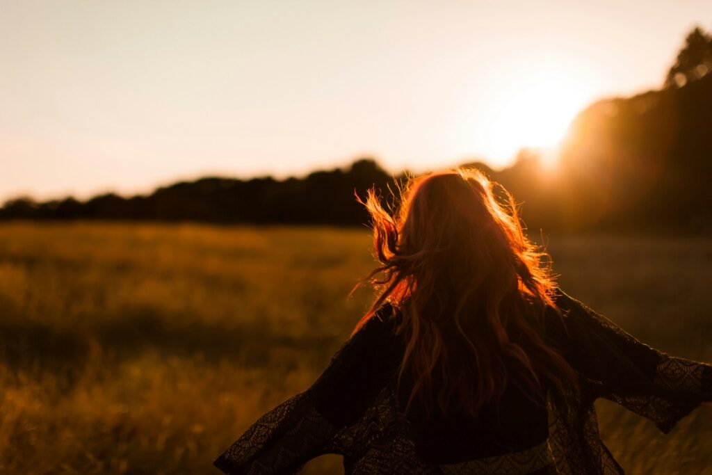 woman standing on grass field, mental health recovery