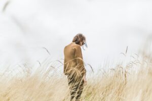 person standing in the middle of wheat field thinking about masturbation addiction