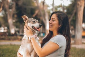 woman playing with dog, how to deal with the death of a pet dog