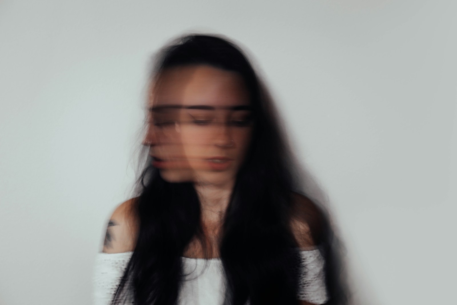 a blurry photo of a woman with glasses, anxiety recovery stages