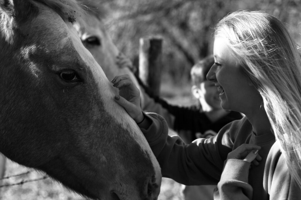 woman holding horse and happy with holistic therapy