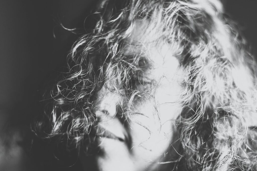 grayscale photography of a woman's face covered with her hair, rehab for depression