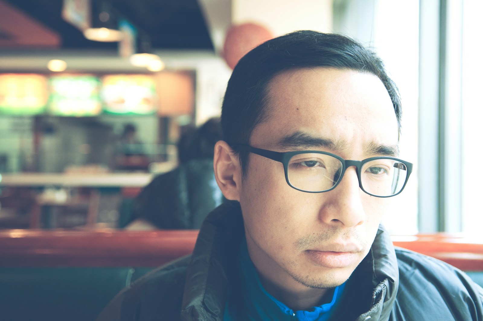 man in black framed eyeglasses and black jacket who struggles with fear of intimacy