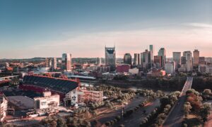 American football arena and out of state rehab option beside building and roadway during daytime