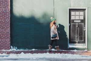 woman standing beside wall and door during daytime afraid of intimacy