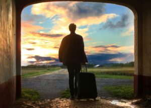 man holding luggage, thinking about what to bring to rehab