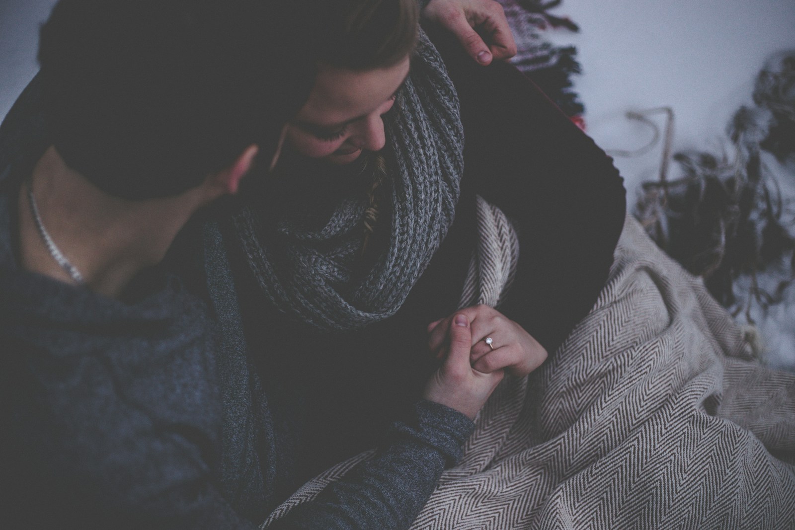 couple with grey blanket wondering, "Is Watching Porn Cheating?"