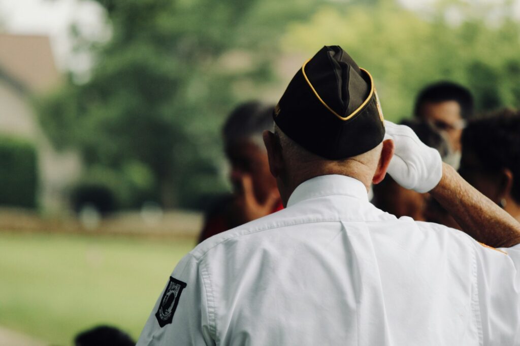 man wearing white uniform saluting, waiting for tricare mental health treatment