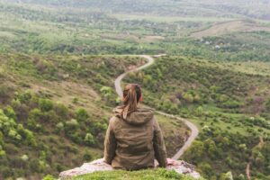 woman sitting on grey cliff navigating porn triggers