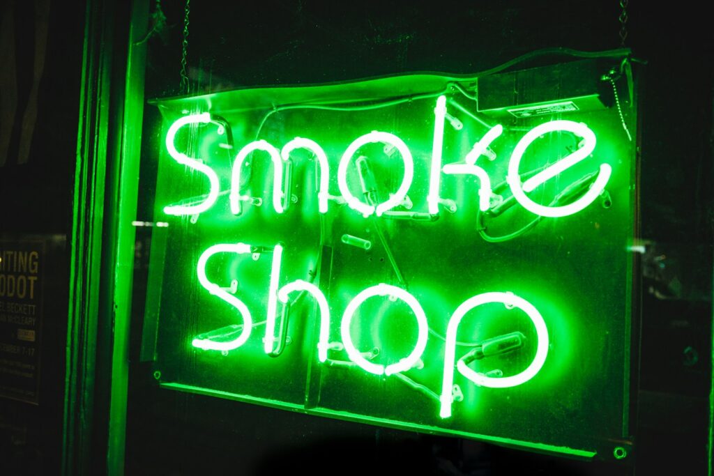 turned on smoke shop NEON signage, advertising gas station drugs