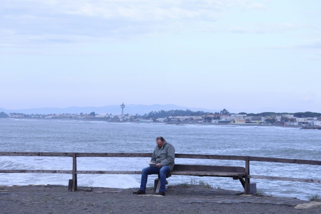 Man struggling with social isolation on a bench