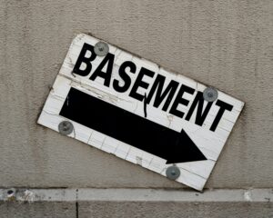 a sign on the side of a building representing a secret sexual basement