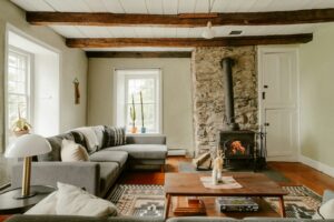 Cozy porn addiction therapist office with lit wood stove and gray sectional